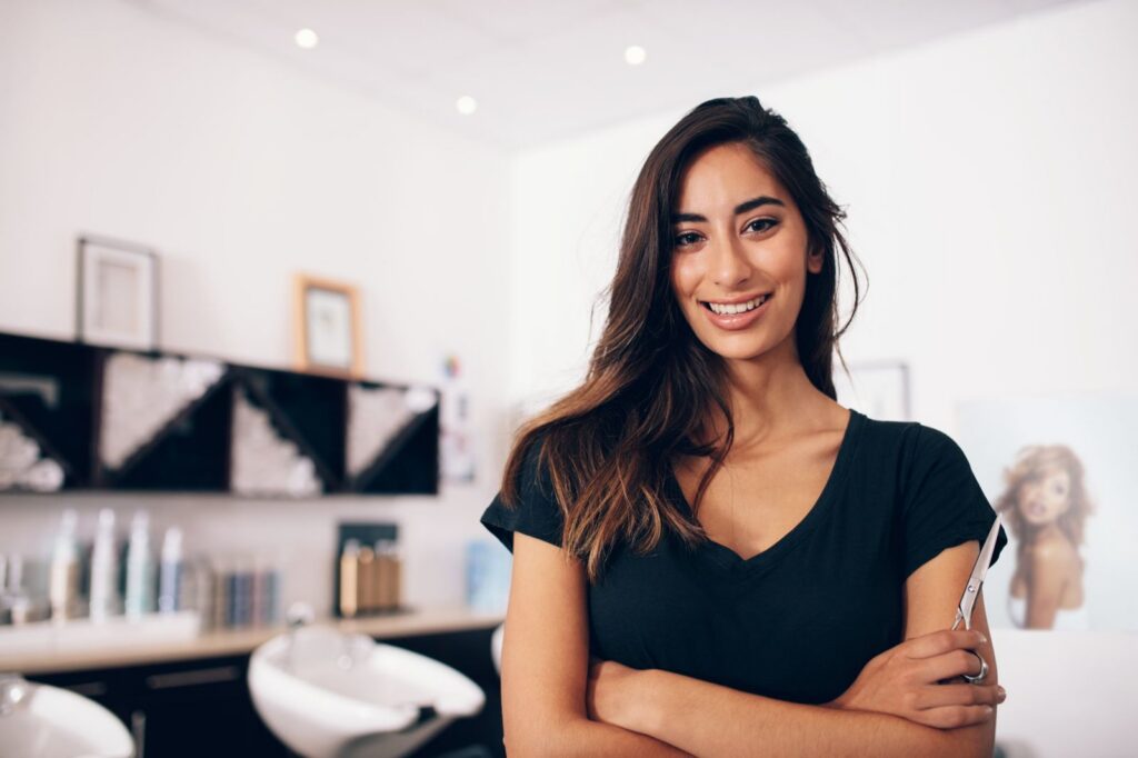 Stylist holding shears in a salon